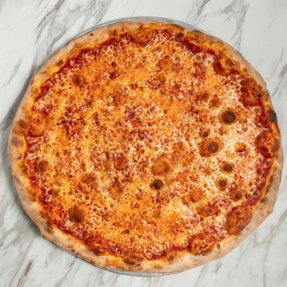 A classic cheese pizza with melted mozzarella and red sauce on a white marble surface.